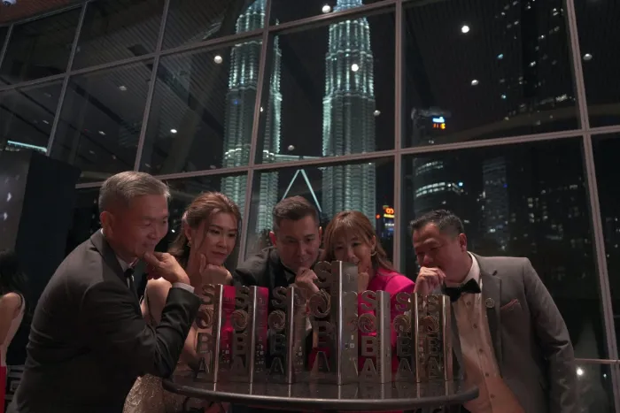 DELUX team celebrating with award trophies at night