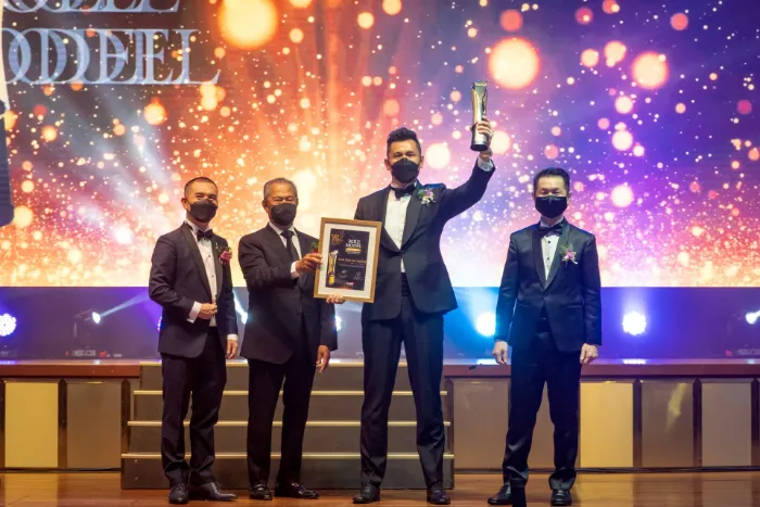 DELUX representatives on stage receiving a business award