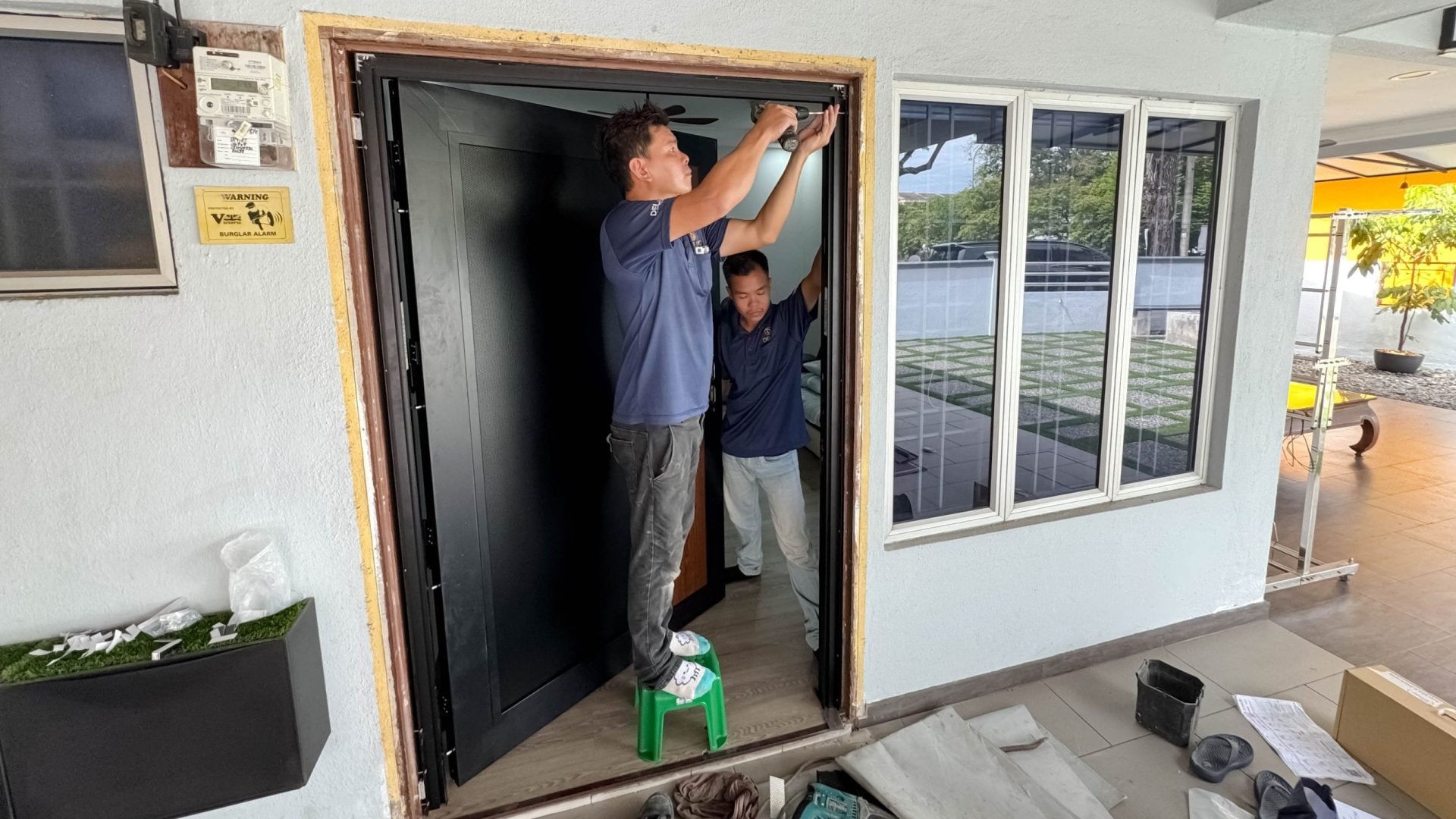 DELUX AlutechDoor Flex frame fitted over an existing door frame without hacking the wall