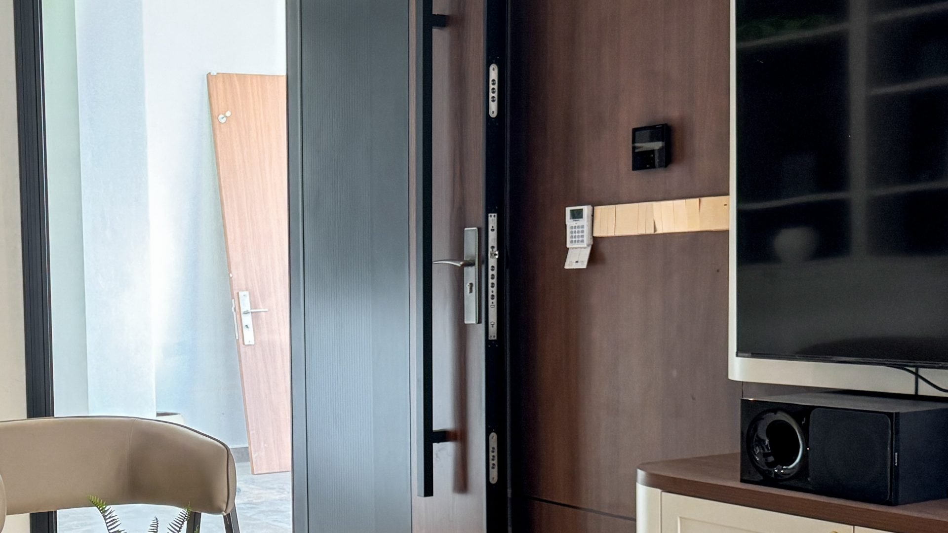Stainless steel multi-point lock bolts along the edge of a DELUX AlutechDoor security door